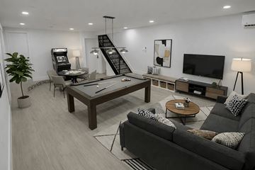 Brooklyn apartment for rent - A modern living room with a black couch and a wooden coffee table.