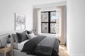 Brooklyn apartment for rent - A bedroom with a large bed and a window with curtains.