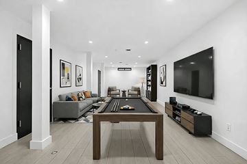 Brooklyn apartment for rent - A modern living room with a pool table and a television.