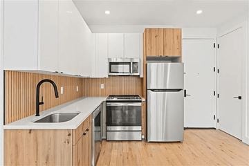 Brooklyn apartment for rent - A modern kitchen with wooden cabinets and stainless steel appliances.