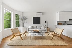 Brooklyn apartment for rent - A living room with a couch, chairs, and a rug.