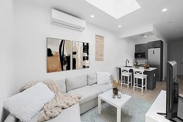 Brooklyn apartment for rent - A living room with a white couch and a coffee table.