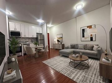 Brooklyn apartment for rent - A modern living room with a grey couch, a coffee table, and a rug.