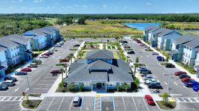 Lakeland apartment for rent - an aerial view of a parking lot with houses and a lake