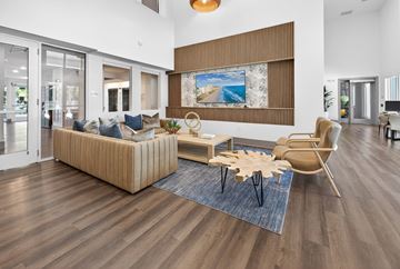 Holly Hill apartment for rent - A living room with a wooden floor and a large painting on the wall.
