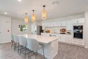 Crestview apartment for rent - A modern kitchen with a large island and grey chairs.