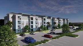 Crystal River apartment for rent - A blue car is parked in a parking lot in front of a building.