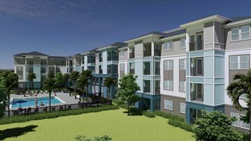 Crystal River apartment for rent - A modern apartment complex with a pool and green lawn.