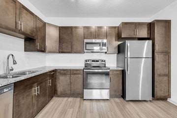Middleburg apartment for rent - a kitchen with stainless steel appliances and wooden cabinets