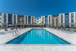 Crestview apartment for rent - A swimming pool in front of a row of apartment buildings.