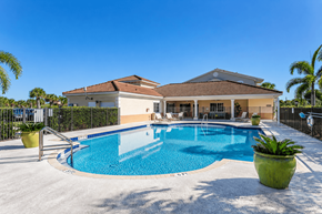 Homestead apartment for rent - A house with a pool in front of it.