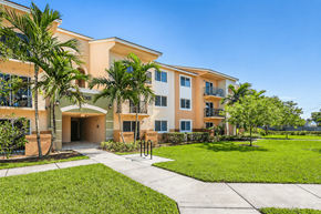 Homestead apartment for rent - A building with a green lawn in front.