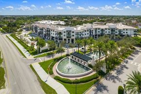 Miami apartment for rent - an aerial view of the resort properties with a fountain in the middle of a grassy area