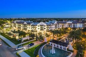 Miami apartment for rent - a large fountain sits in front of a large building
