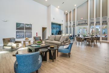 Cocoa apartment for rent - A living room with a blue chair in the foreground.