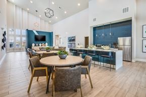 Cocoa apartment for rent - A modern dining room with a round table and chairs.