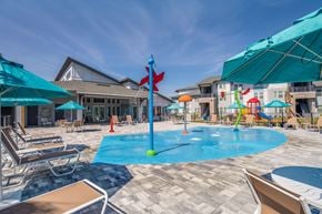 Cocoa apartment for rent - A pool area with a blue umbrella and a red flag.