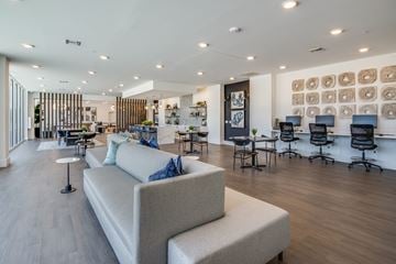 Bradenton apartment for rent - A modern living room with a white sofa and a wooden floor.