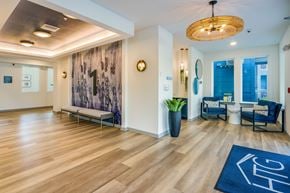 Crystal River apartment for rent - A hallway with a blue rug on the floor and a wooden bench.