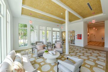 Miami apartment for rent - a living room with couches and chairs and a table