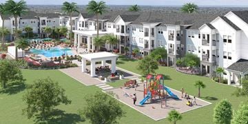 Holly Hill apartment for rent - A large white building with a pool and playground in front.