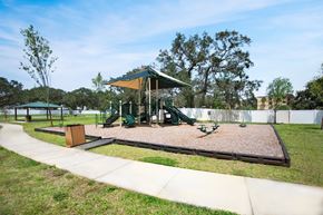 Holiday apartment for rent - A playground with a green canopy and a slide.