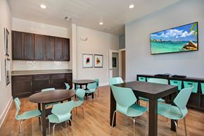 Holiday apartment for rent - A modern dining room with a wooden table and chairs.