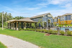 Brooksville apartment for rent - A building with a pool in front of it.