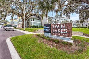 Lakeland apartment for rent - a sign that says twin lakes estates with houses in the background