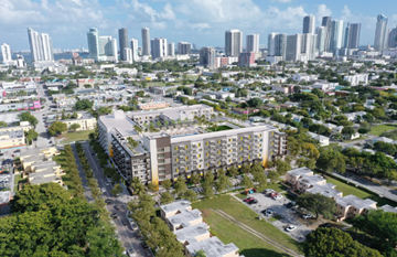Miami apartment for rent - A cityscape with a large building in the foreground and several high-rise buildings in the background.
