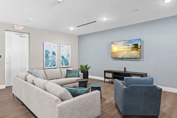 Miami apartment for rent - A living room with a couch, chair, and a painting on the wall.