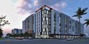 Homestead apartment for rent - A modern multi-story building with a red and white stripe on the top floor is depicted.