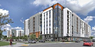 Homestead apartment for rent - A modern multi-story building with a red car parked in front.