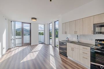 Homestead apartment for rent - A modern kitchen with wooden cabinets and a stainless steel dishwasher.