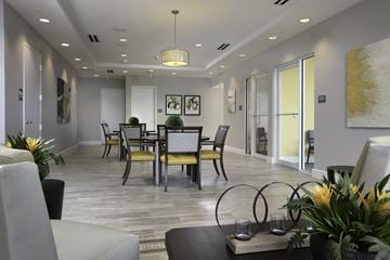 Miami apartment for rent - a living room and dining room with a table and chairs