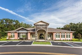 Brooksville apartment for rent - The front of a building with the words "Freedom Gardens" on it.