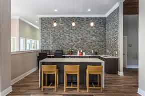 Brooksville apartment for rent - a kitchen with a large island with four chairs in front of it