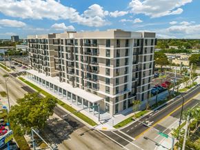 Palmetto Bay apartment for rent - A large building with a parking lot in front of it.