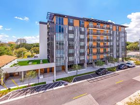 Ft. Lauderdale apartment for rent - A modern multi-story building with orange and grey balconies.