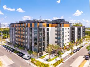 Ft. Lauderdale apartment for rent - A modern multi-story building with a mix of orange, gray, and black colors.