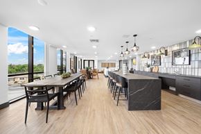 Deerfield Beach apartment for rent - A modern kitchen and dining area with a long table and chairs.