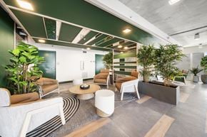 Ft. Lauderdale apartment for rent - A modern office space with a green accent wall and a variety of seating options.