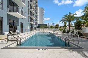 Hollywood apartment for rent - A swimming pool in front of a building with the number 5 on it.