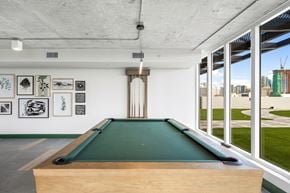 Ft. Lauderdale apartment for rent - A pool table in a room with pictures on the wall.