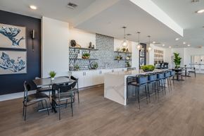Bradenton apartment for rent - A modern dining area with a long table and chairs.
