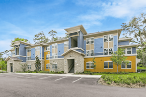 Brooksville apartment for rent - A modern two-story building with a parking lot in front.