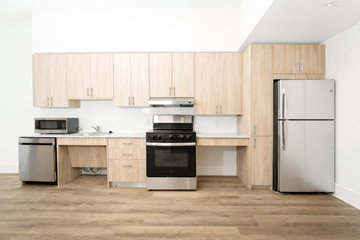 Miami apartment for rent - A kitchen with wooden cabinets and stainless steel appliances.