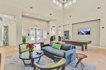 Palm Coast apartment for rent - A living room with a blue couch and a coffee table.