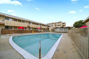 North Hollywood apartment for rent - A swimming pool in a courtyard surrounded by buildings.