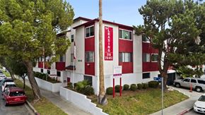 Wilmington apartment for rent - A red and white building with the words "LEASING" and "310" on it.